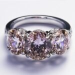 How did Queen Elizabeth II's engagement ring influence three-stone ring designs