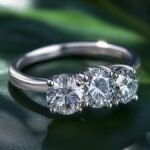What makes Grace Kelly's engagement ring iconic, and how has it influenced three-stone ring designs