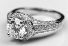 Woman's hand with an upgraded halo engagement ring