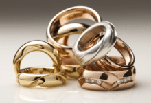 Photo of hands wearing different metal rings