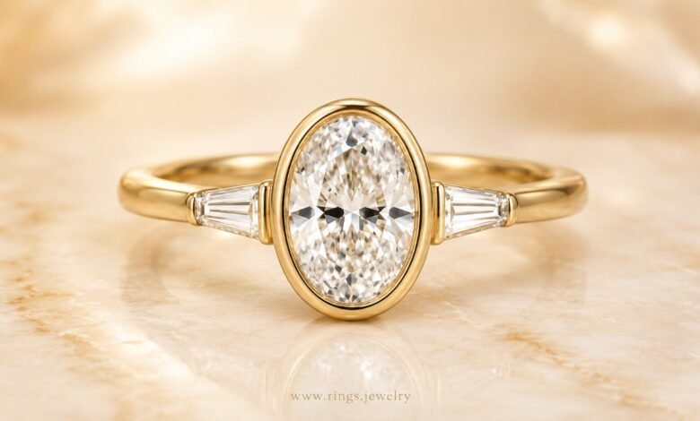 Oval bezel diamond engagement ring in yellow gold close up