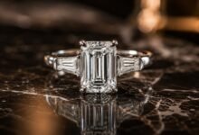 Emerald cut diamond engagement ring close up on dark marble