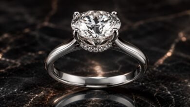 Hidden halo diamond engagement ring close up on dark marble