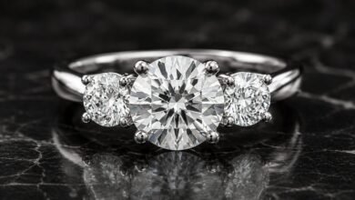 Three-stone diamond engagement ring close up on dark marble