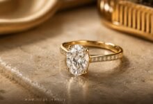 Oval yellow gold diamond engagement ring on warm marble